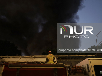 Firefighters get ready to put out a fire in the shoe market in Tepito, Historic Center of Mexico City. (