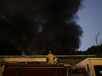 Firefighters get ready to put out a fire in the shoe market in Tepito, Historic Center of Mexico City. (