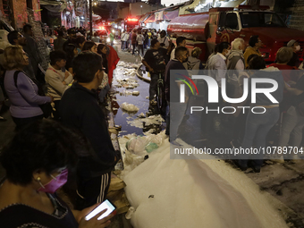 Merchants try to help firefighters after a fire in the shoe market in Tepito, Historic Center of Mexico City. (