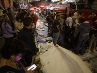 Merchants try to help firefighters after a fire in the shoe market in Tepito, Historic Center of Mexico City. (