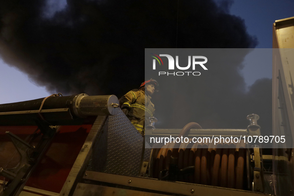 Firefighters get ready to put out a fire in the shoe market in Tepito, Historic Center of Mexico City. 