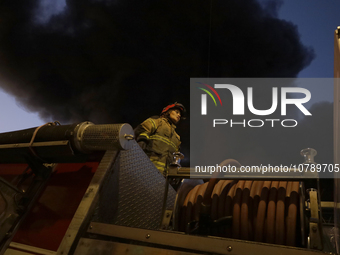 Firefighters get ready to put out a fire in the shoe market in Tepito, Historic Center of Mexico City. (