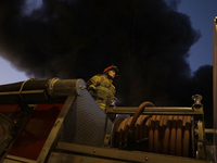 Firefighters get ready to put out a fire in the shoe market in Tepito, Historic Center of Mexico City. (