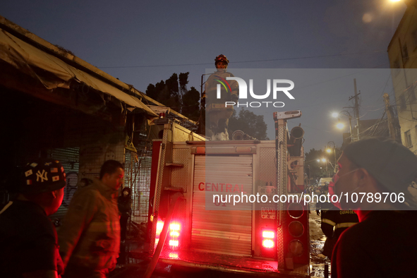 Firefighters get ready to put out a fire in the shoe market in Tepito, Historic Center of Mexico City. 