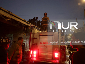 Firefighters get ready to put out a fire in the shoe market in Tepito, Historic Center of Mexico City. (