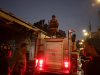 Firefighters get ready to put out a fire in the shoe market in Tepito, Historic Center of Mexico City. (