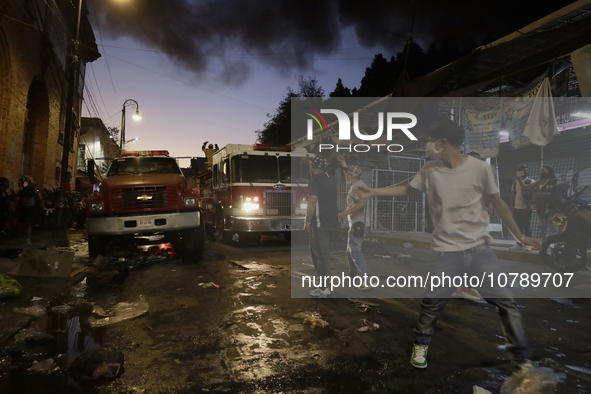 Merchants try to help firefighters after a fire in the shoe market in Tepito, Historic Center of Mexico City. 