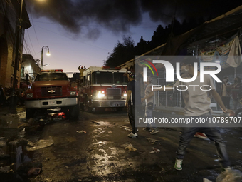 Merchants try to help firefighters after a fire in the shoe market in Tepito, Historic Center of Mexico City. (