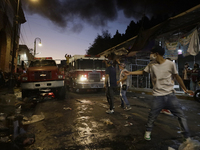 Merchants try to help firefighters after a fire in the shoe market in Tepito, Historic Center of Mexico City. (