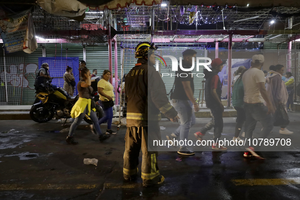 Firefighters get ready to put out a fire in the shoe market in Tepito, Historic Center of Mexico City. 