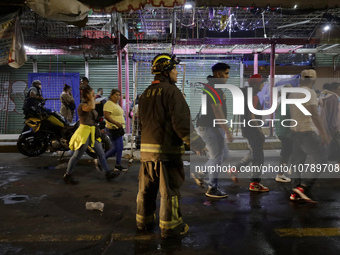 Firefighters get ready to put out a fire in the shoe market in Tepito, Historic Center of Mexico City. (