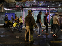 Firefighters get ready to put out a fire in the shoe market in Tepito, Historic Center of Mexico City. (