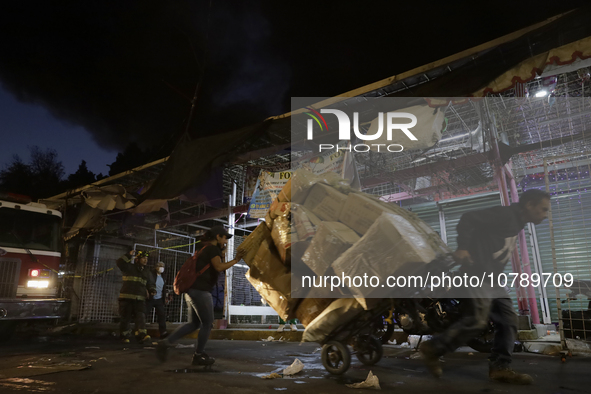 Merchants try to help firefighters after a fire in the shoe market in Tepito, Historic Center of Mexico City. 