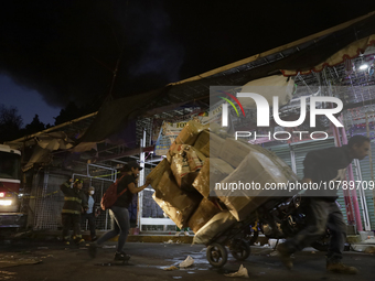 Merchants try to help firefighters after a fire in the shoe market in Tepito, Historic Center of Mexico City. (