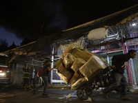 Merchants try to help firefighters after a fire in the shoe market in Tepito, Historic Center of Mexico City. (