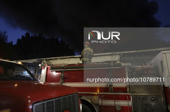 Firefighters get ready to put out a fire in the shoe market in Tepito, Historic Center of Mexico City. 