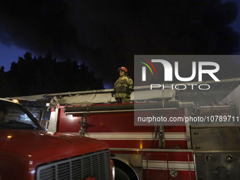 Firefighters get ready to put out a fire in the shoe market in Tepito, Historic Center of Mexico City. (