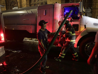 Firefighters and merchants coordinate to put out a fire in the shoe market in Tepito, Historic Center of Mexico City. (