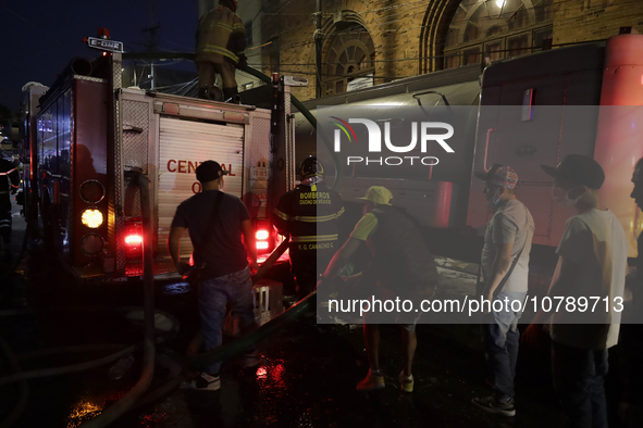 Firefighters and merchants coordinate to put out a fire in the shoe market in Tepito, Historic Center of Mexico City. 