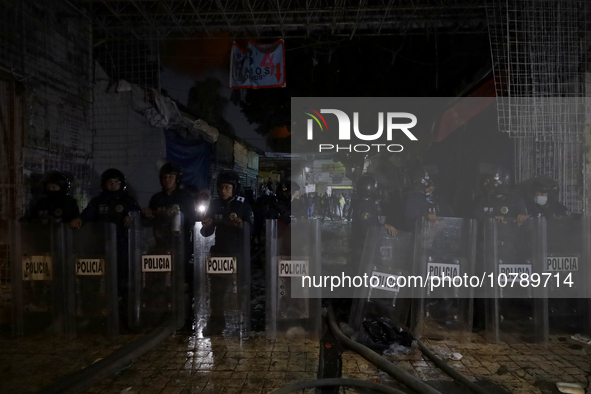 Police protect the area after a fire in the shoe market in Tepito, Historic Center of Mexico City. 