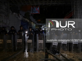 Police protect the area after a fire in the shoe market in Tepito, Historic Center of Mexico City. (