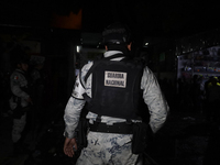 Police protect the area after a fire in the shoe market in Tepito, Historic Center of Mexico City. (