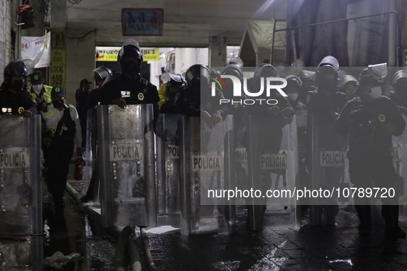 Police protect the area after a fire in the shoe market in Tepito, Historic Center of Mexico City. 