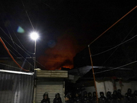 Below, police protect the area after a fire in the shoe market in Tepito, Historic Center of Mexico City. (