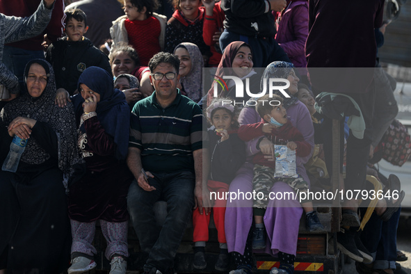 Palestinians fleeing Gaza City and other parts of northern Gaza, carry some belongings as they walk along a road leading to the southern are...