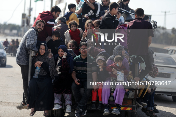 Palestinians fleeing Gaza City and other parts of northern Gaza, carry some belongings as they walk along a road leading to the southern are...