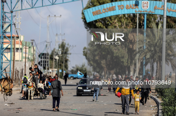 Palestinians fleeing Gaza City and other parts of northern Gaza, carry some belongings as they walk along a road leading to the southern are...