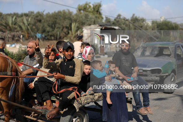 Palestinians fleeing Gaza City and other parts of northern Gaza, carry some belongings as they walk along a road leading to the southern are...