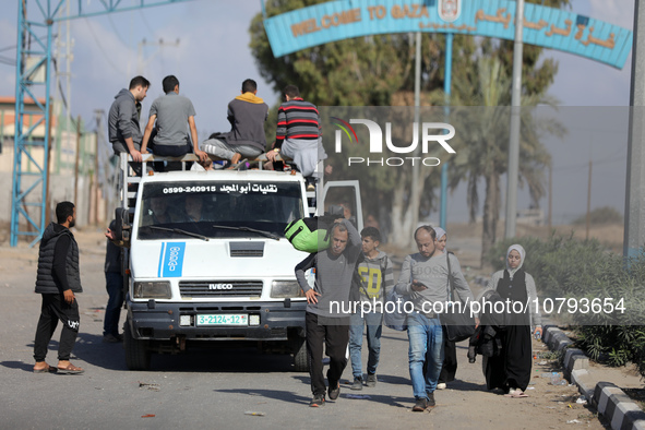 Palestinians fleeing Gaza City and other parts of northern Gaza, carry some belongings as they walk along a road leading to the southern are...