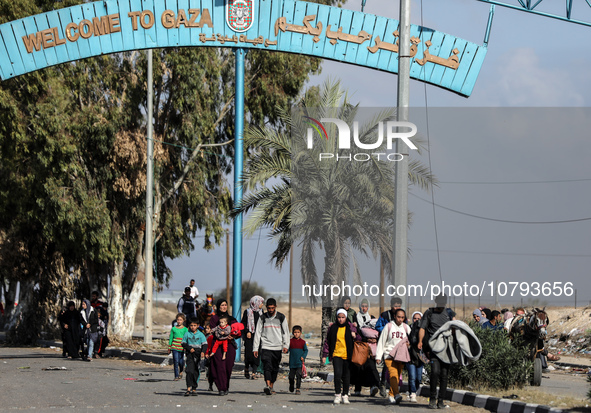 Palestinians fleeing Gaza City and other parts of northern Gaza, carry some belongings as they walk along a road leading to the southern are...