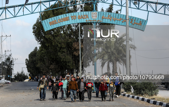 Palestinians fleeing Gaza City and other parts of northern Gaza, carry some belongings as they walk along a road leading to the southern are...