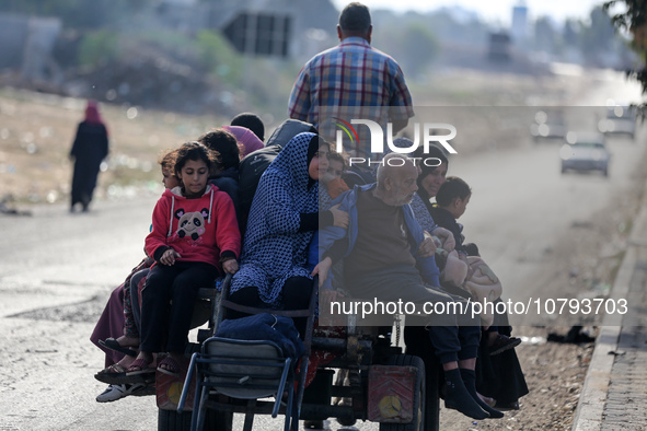 Palestinians fleeing Gaza City and other parts of northern Gaza, carry some belongings as they walk along a road leading to the southern are...