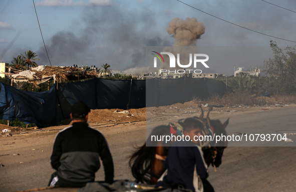 Palestinians fleeing Gaza City and other parts of northern Gaza, carry some belongings as they walk along a road leading to the southern are...