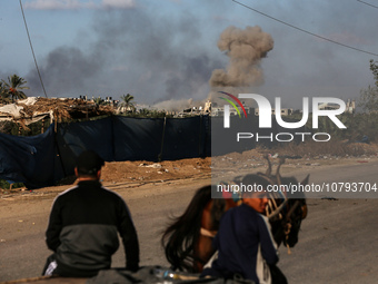 Palestinians fleeing Gaza City and other parts of northern Gaza, carry some belongings as they walk along a road leading to the southern are...