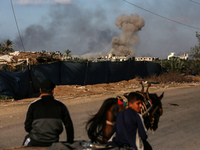 Palestinians fleeing Gaza City and other parts of northern Gaza, carry some belongings as they walk along a road leading to the southern are...