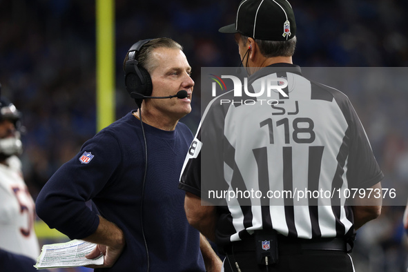 Chicago Bears head coach Matt Eberflus talks to side judge David Meslow during the first half of an NFL football game between the Chicago Be...