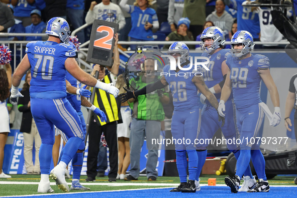 Detroit Lions running back Jahmyr Gibbs (26) is congratulated by teamates after scoring a touchdown during the first half of an NFL football...