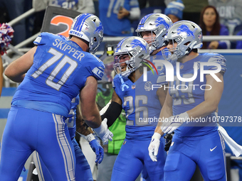 Detroit Lions running back Jahmyr Gibbs (26) is congratulated by teamates after scoring a touchdown during the first half of an NFL football...