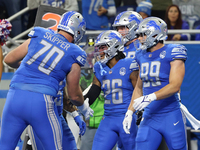 Detroit Lions running back Jahmyr Gibbs (26) is congratulated by teamates after scoring a touchdown during the first half of an NFL football...