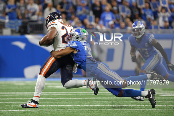 Chicago Bears running back Khalil Herbert (24) runs the ball against Detroit Lions safety Brian Branch (32) during the first half of an NFL...