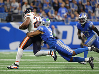 Chicago Bears running back Khalil Herbert (24) runs the ball against Detroit Lions safety Brian Branch (32) during the first half of an NFL...