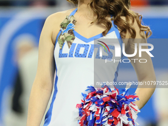 A member of the Detroit Lions cheer squad waits to welcome Lions players to the field ahead of an NFL  football game between the Detroit Lio...