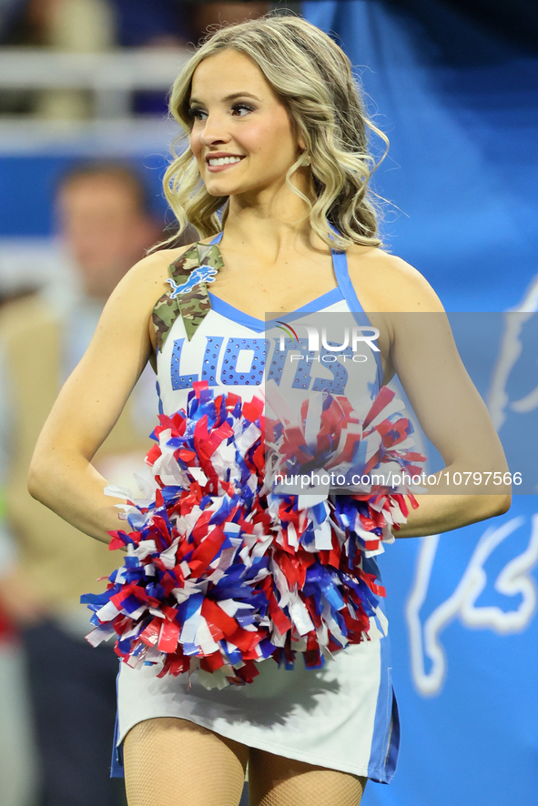 A member of the Detroit Lions cheer squad waits to welcome Lions players to the field ahead of an NFL  football game between the Detroit Lio...