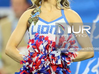 A member of the Detroit Lions cheer squad waits to welcome Lions players to the field ahead of an NFL  football game between the Detroit Lio...