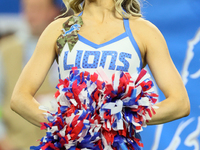 A member of the Detroit Lions cheer squad waits to welcome Lions players to the field ahead of an NFL  football game between the Detroit Lio...