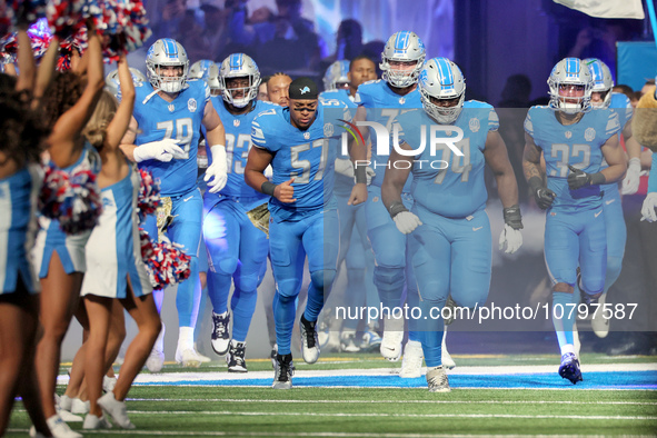 Detroit Lions players run onto the field ahead of an NFL  football game between the Detroit Lions and the Chicago Bears in Detroit, Michigan...